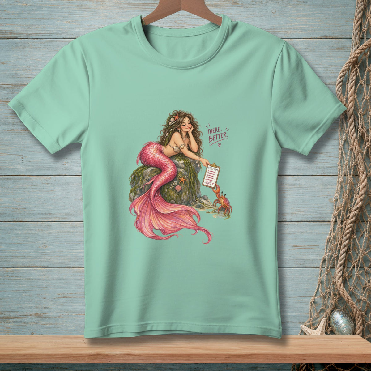 Mermaid with pink tail lounging on rock, showing a crab a clipboard with "Expectations" and "Joy" listed.