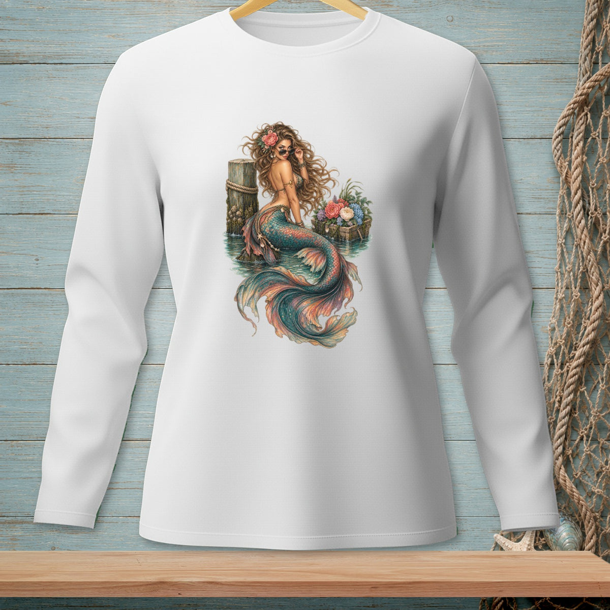 White long-sleeve shirt with a graphic of a mermaid with flowers in her hair.