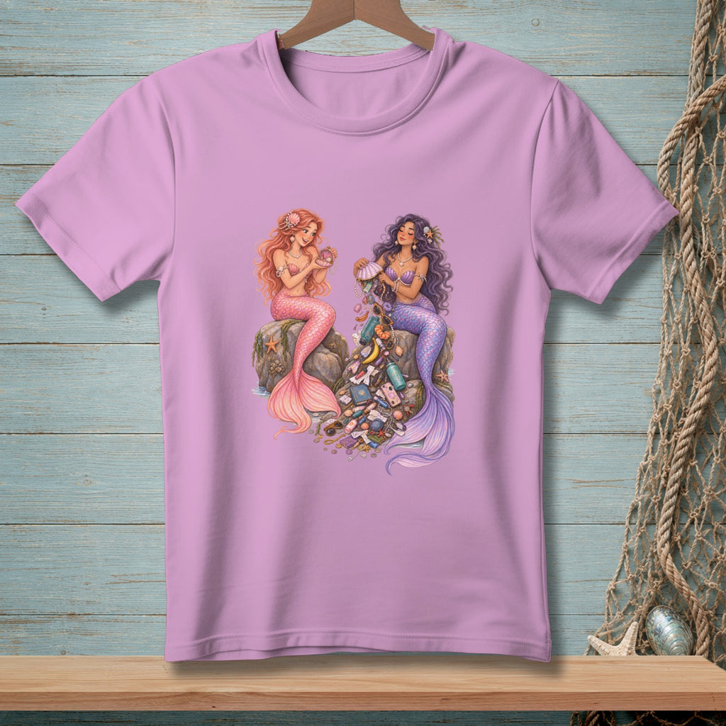 Two mermaids sit on rocks, one with pink tail, the other with purple, surrounded by trash.