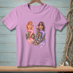 Two mermaids sit on rocks, one with pink tail, the other with purple, surrounded by trash.