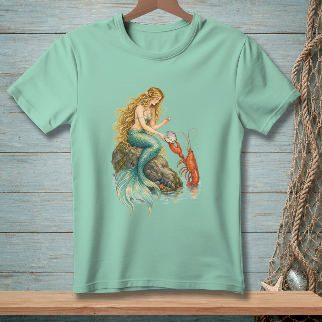 Mint t-shirt with illustration of a mermaid and lobster by a rock.