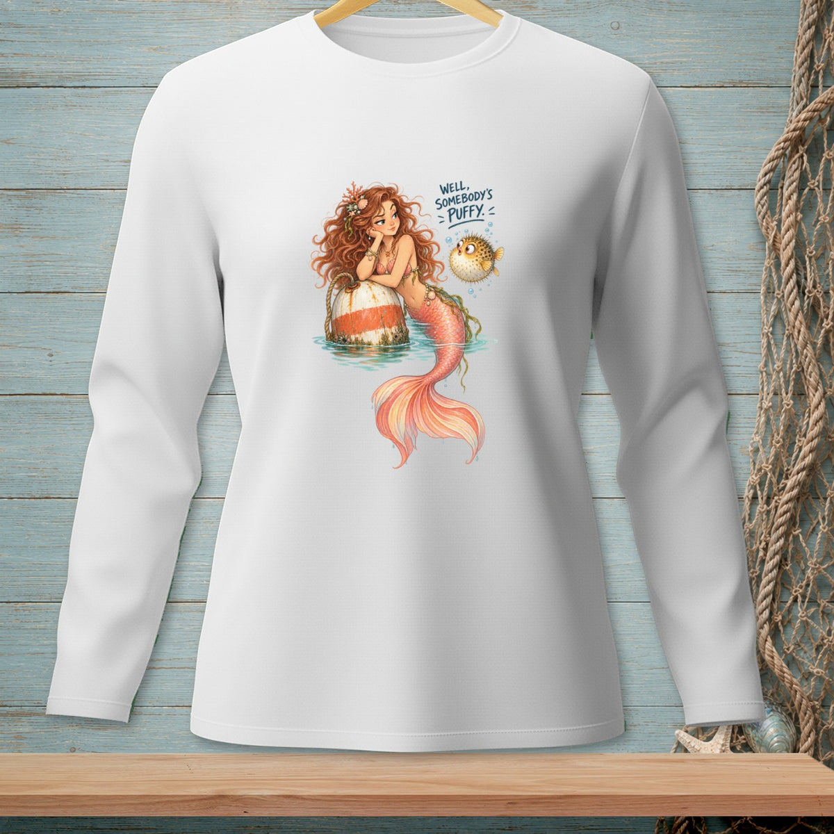 Mermaid leaning on buoy with pufferfish and text "Well, Somebody's Puffy"
