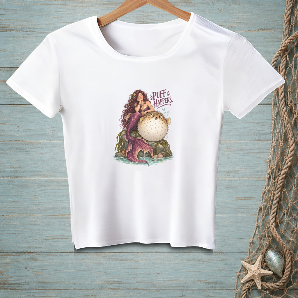 White t-shirt with mermaid and pufferfish graphic and text "PUFF HAPPENS."