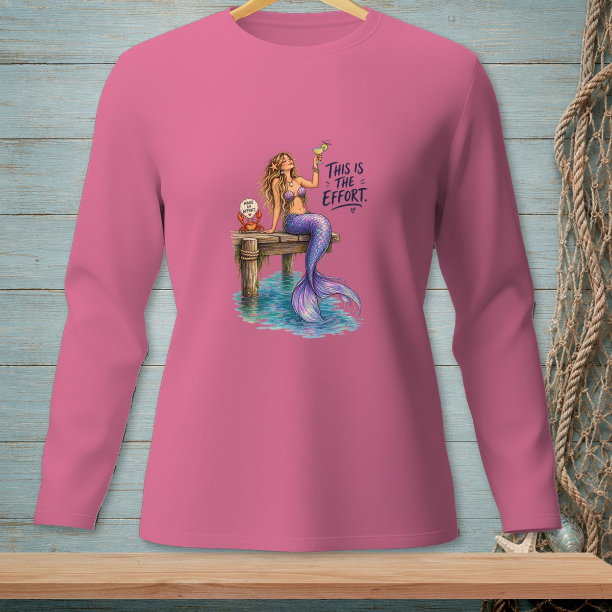 Pink long-sleeve shirt with a mermaid and crab illustration and text.