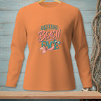 Orange long-sleeve shirt with "Resting Beach Face" and mermaid tail graphic.
