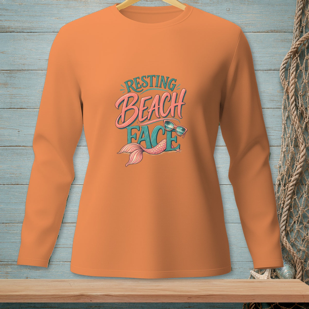 Orange long-sleeve shirt with "Resting Beach Face" and mermaid tail graphic.