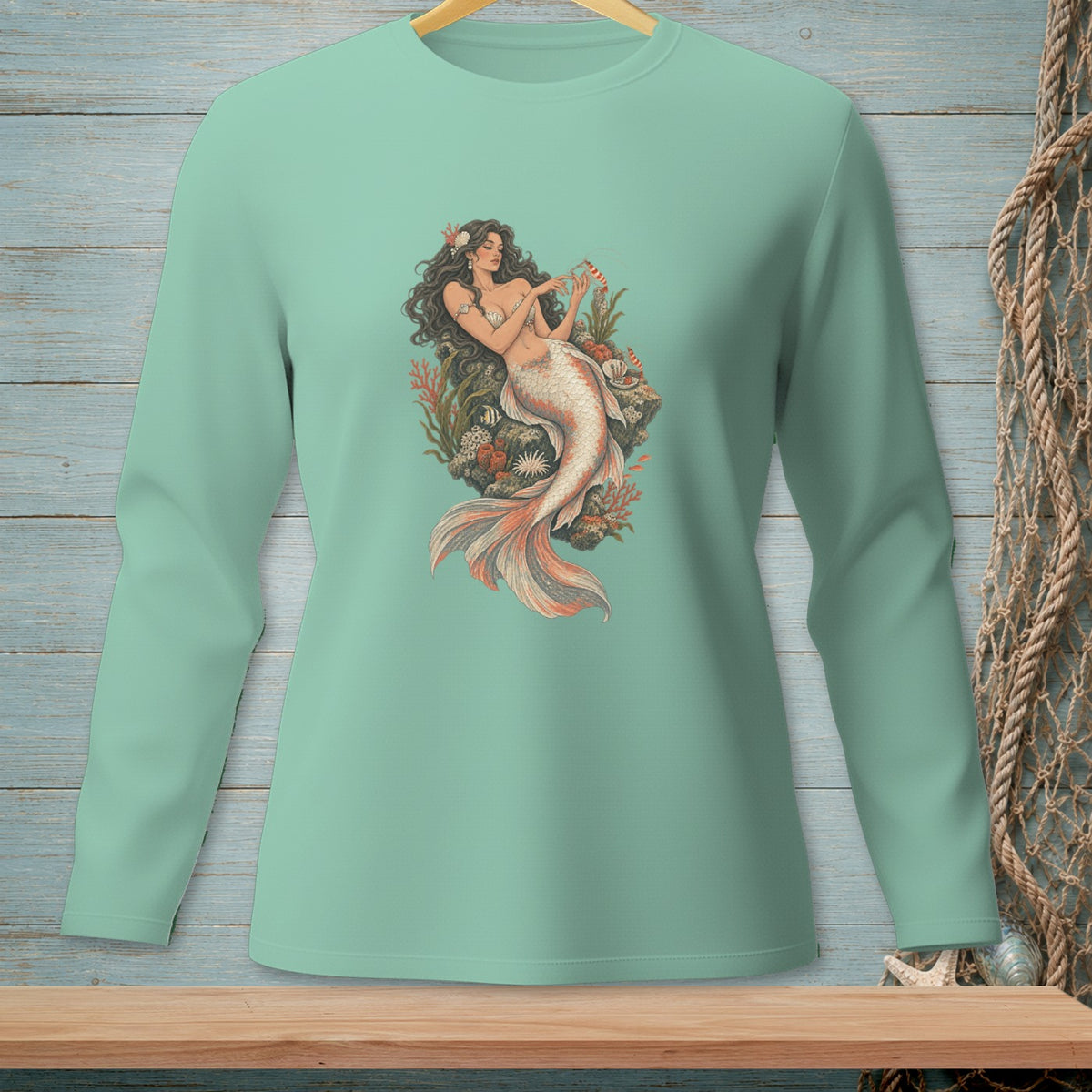 Long-sleeved teal shirt with a distressed mermaid illustration on the front.