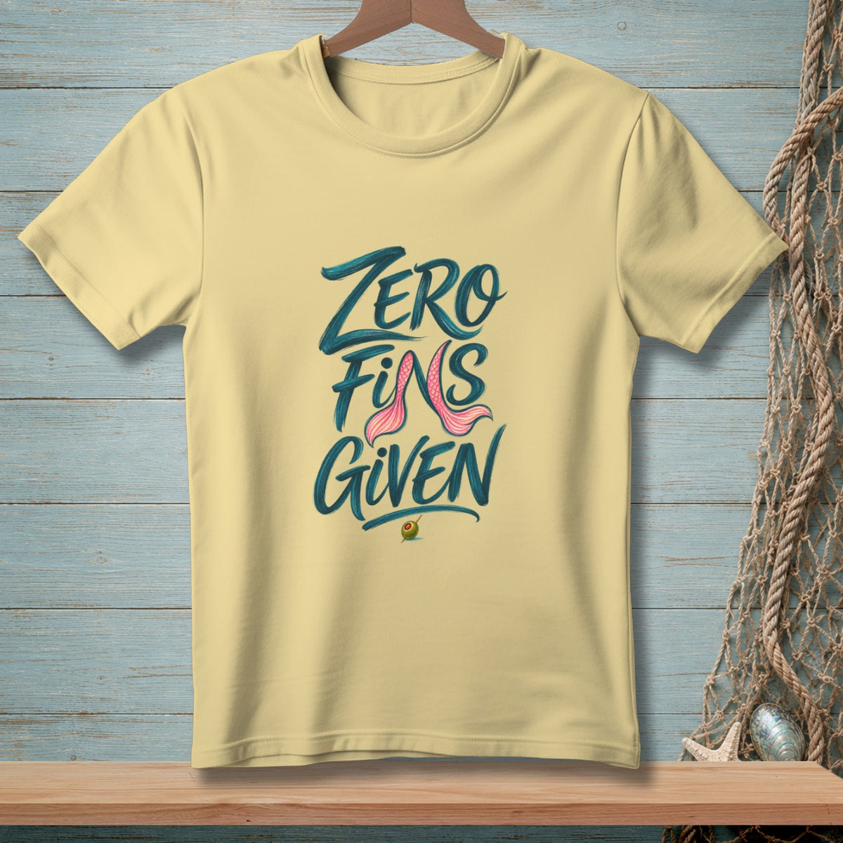 Yellow t-shirt with "Zero Fins Given" text and mermaid tail graphic.