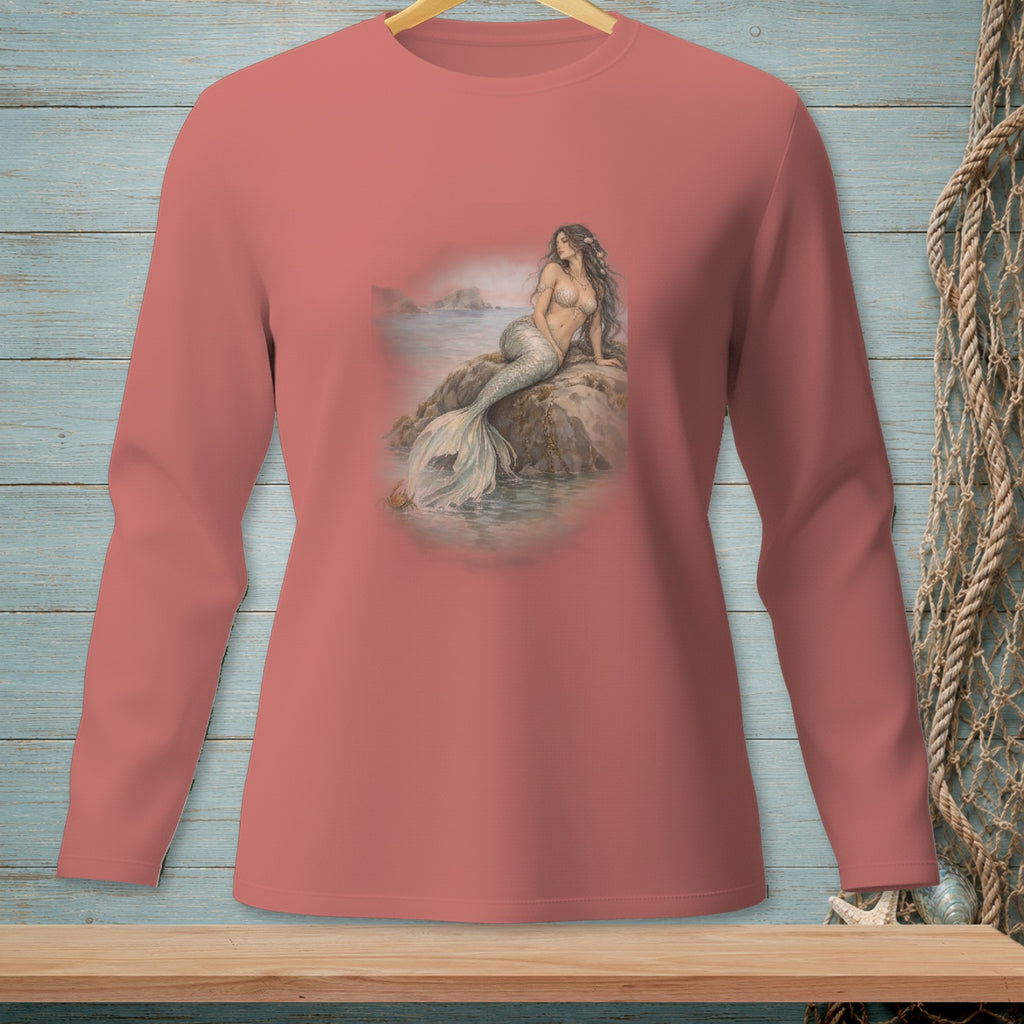 Long-sleeve shirt with a watercolor mermaid sitting on a rock by the sea.