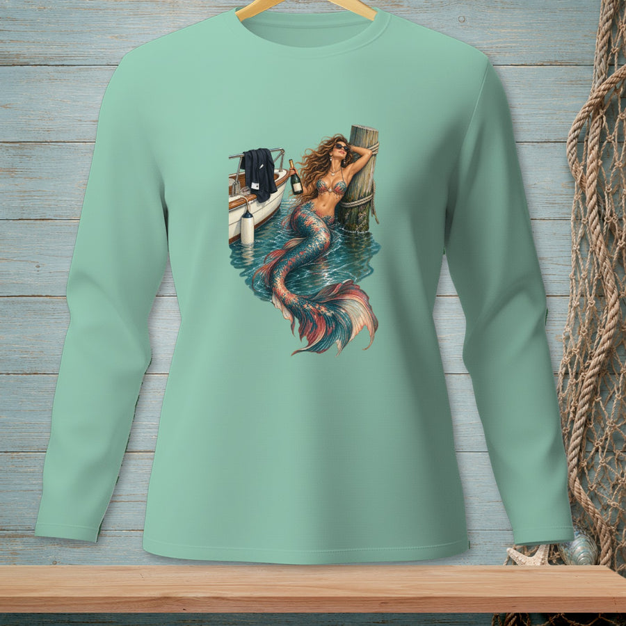 Mint green long-sleeve shirt featuring a mermaid lounging by a boat and a wooden post.