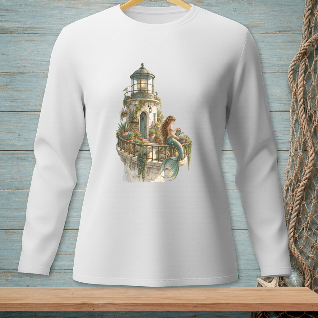 Long-sleeve shirt with a watercolor print of a mermaid watering plants on a lighthouse balcony.