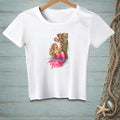 White t-shirt with a graphic of a mermaid and octopus near a wooden post.