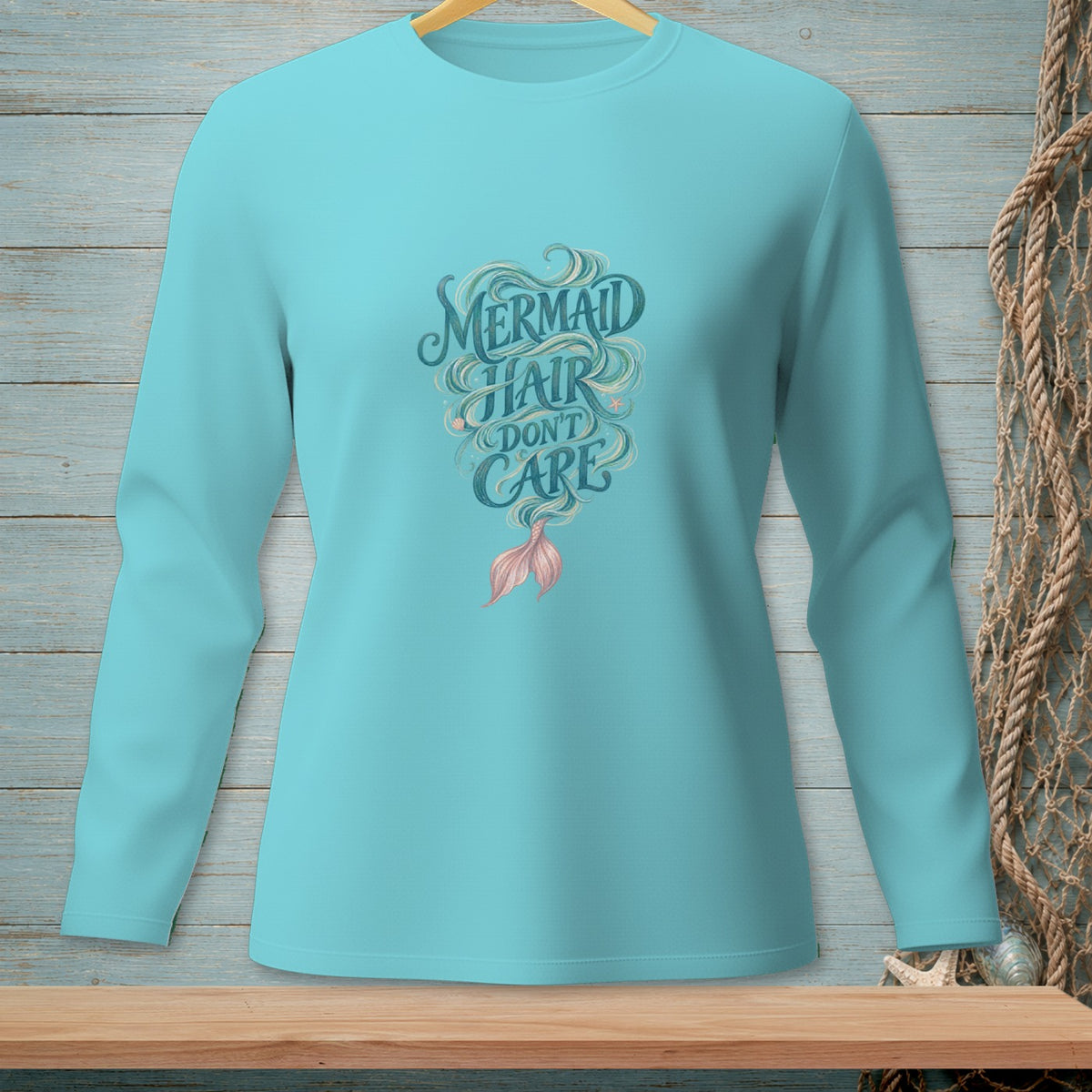 Long sleeve teal shirt with "Mermaid Hair Don't Care" text and mermaid tail graphic.