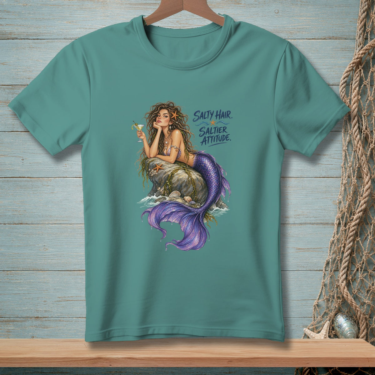 Teal t-shirt with a mermaid holding a cocktail and the text "Salty Hair. Saltier Attitude."