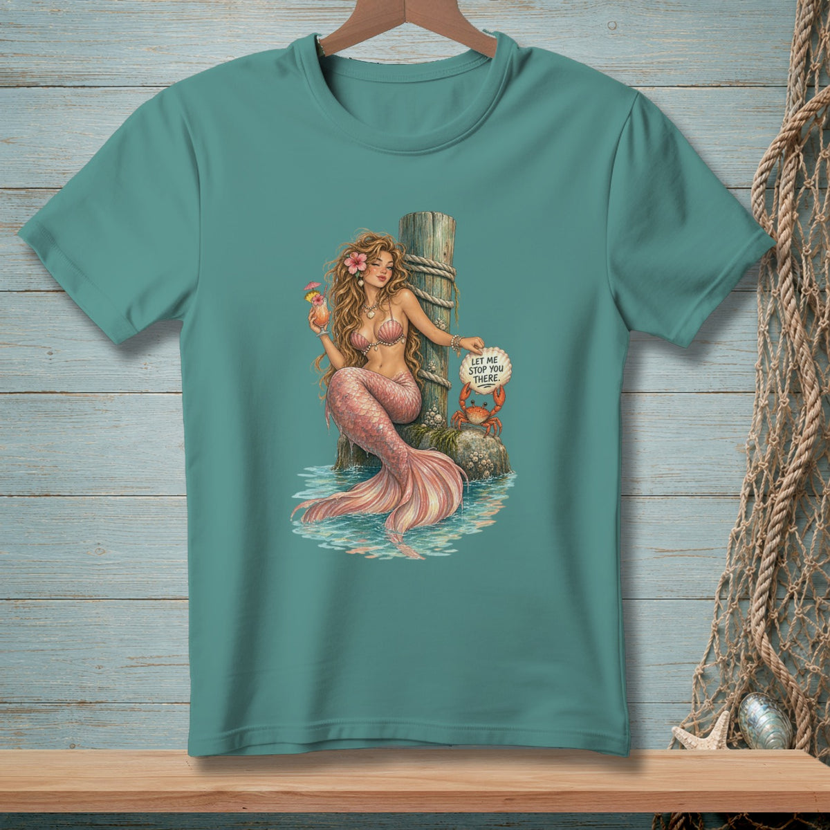 Mermaid holding a drink, sitting by a post with a crab holding a sign that says "Let me stop you there."