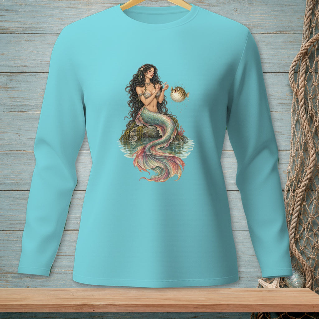 Mermaid sitting on rock with pufferfish on turquoise long sleeve shirt.