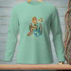 Mermaid with crab sits on a dock by the ocean.