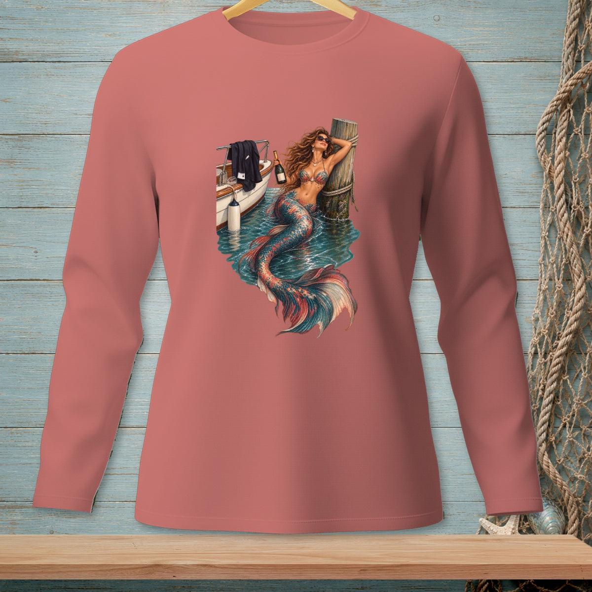 Mermaid on a boat with a bottle of champagne leans on a pier.