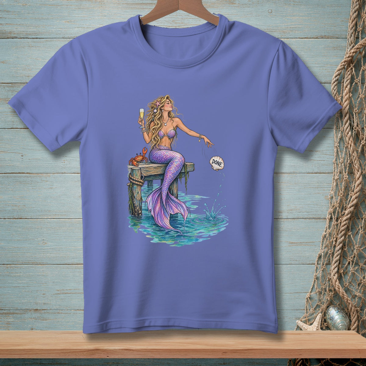 Mermaid on dock with champagne, dropping shell labeled "DONE" into water.
