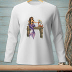 White long-sleeve shirt with a mermaid and crab illustration sitting on a wooden dock.