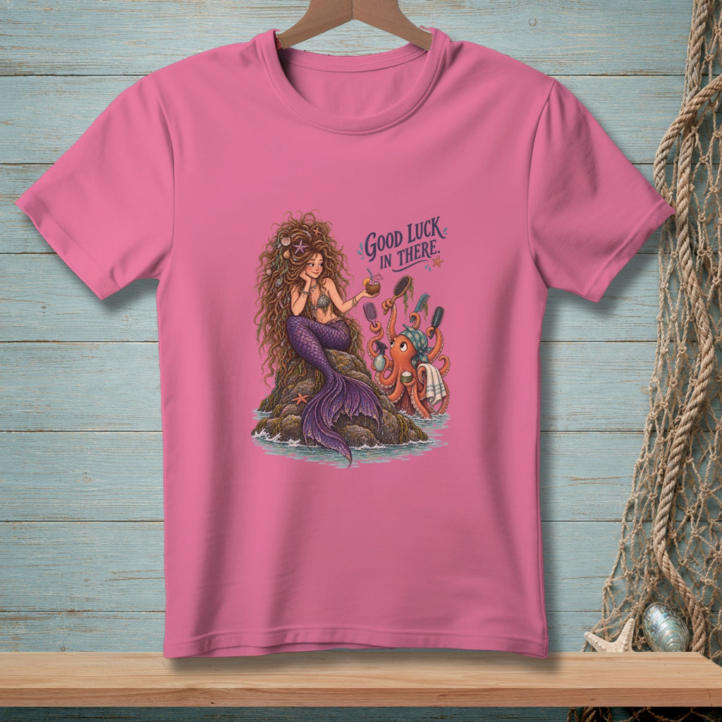Pink t-shirt featuring a mermaid and octopus on a rock with text "Good Luck In There."