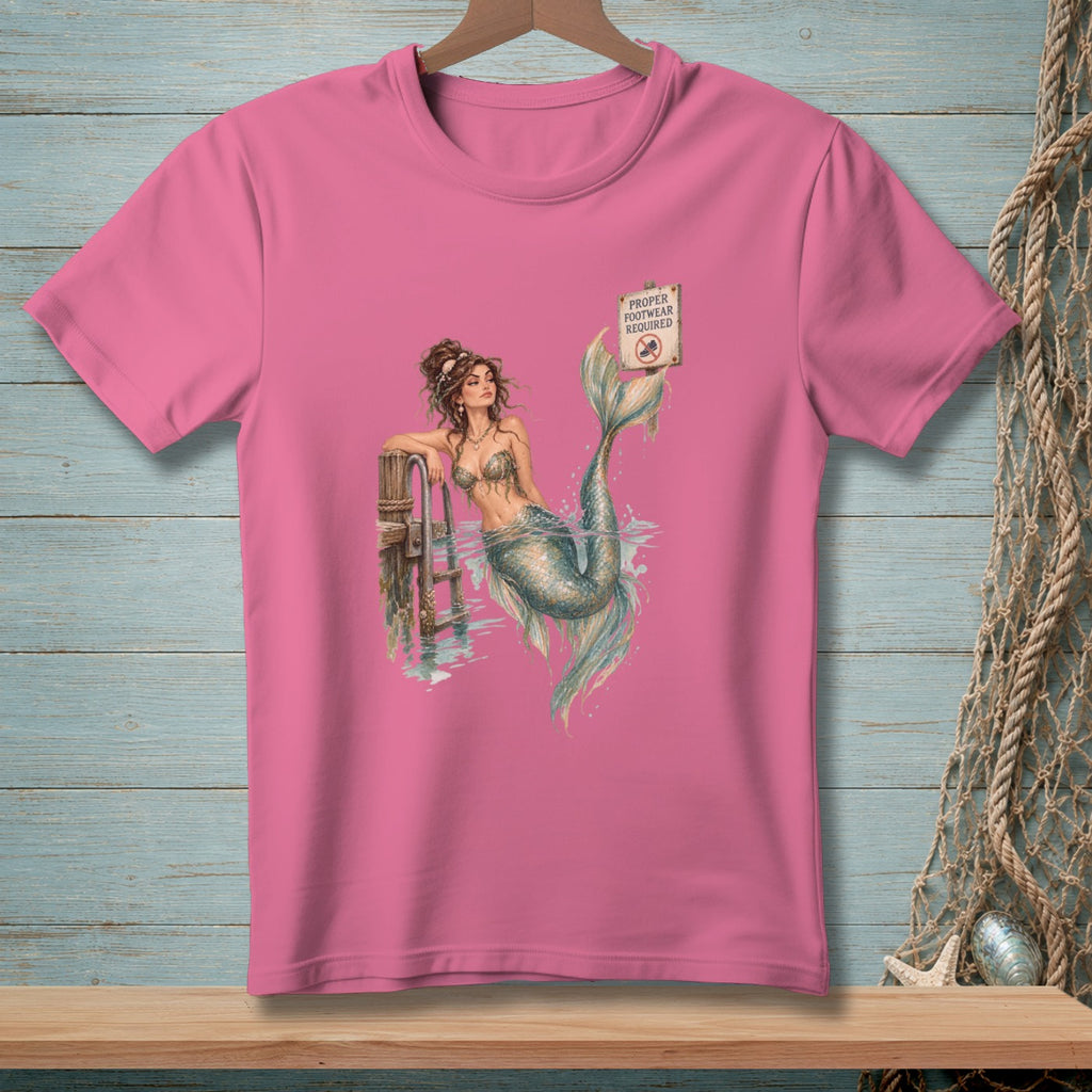 Pink t-shirt with a mermaid at a pier and "Proper Footwear Required" sign.