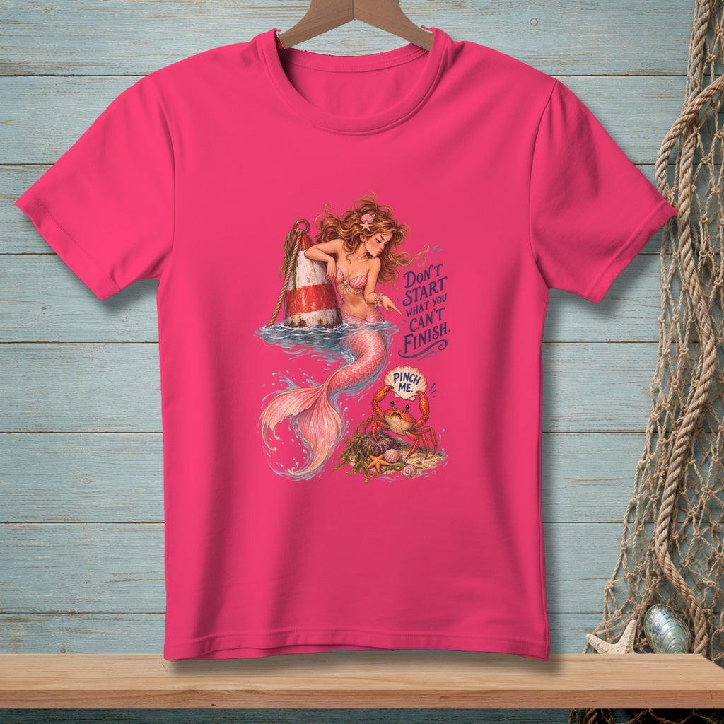 Pink t-shirt with a mermaid, buoy, and crab graphic. Text says "Don't start what you can't finish. Pinch me."
