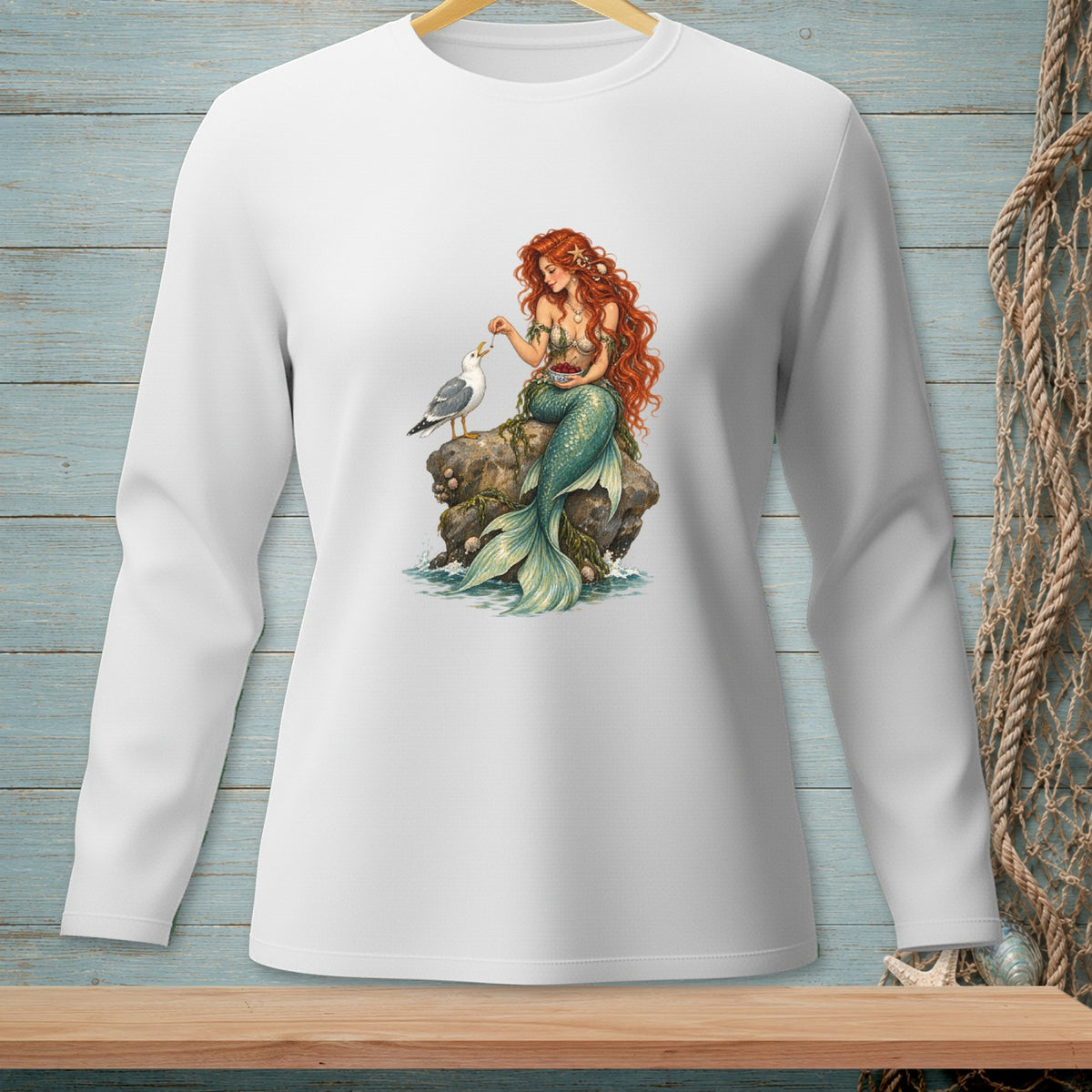 Mermaid with red hair feeding a seagull on a rock, wearing a green tail.