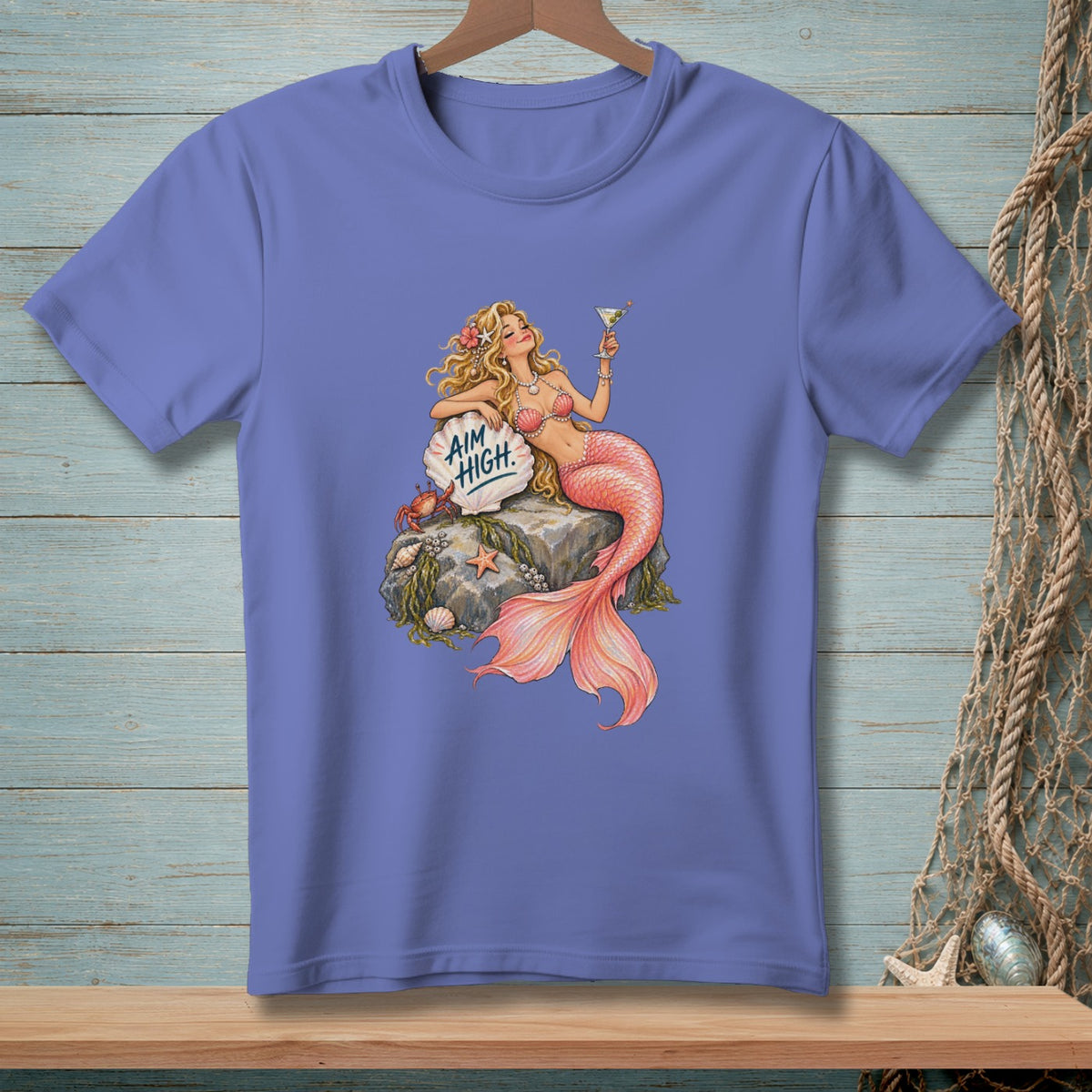 Illustration of a mermaid with pink tail holding a martini glass and a crab on rocks.