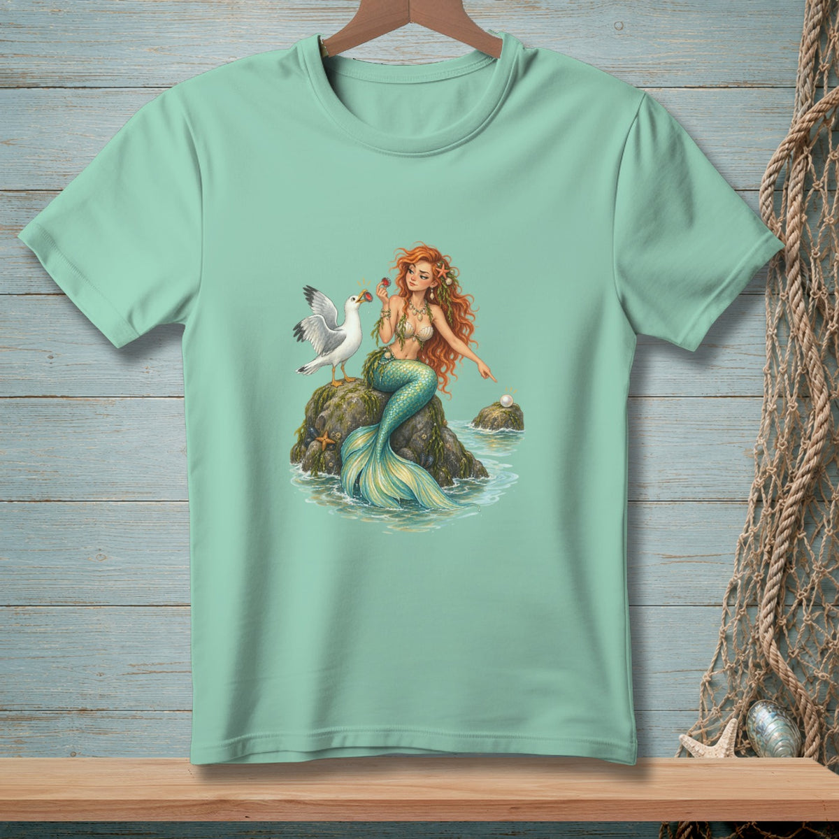 Mint t-shirt featuring a mermaid with a seagull and a pearl.