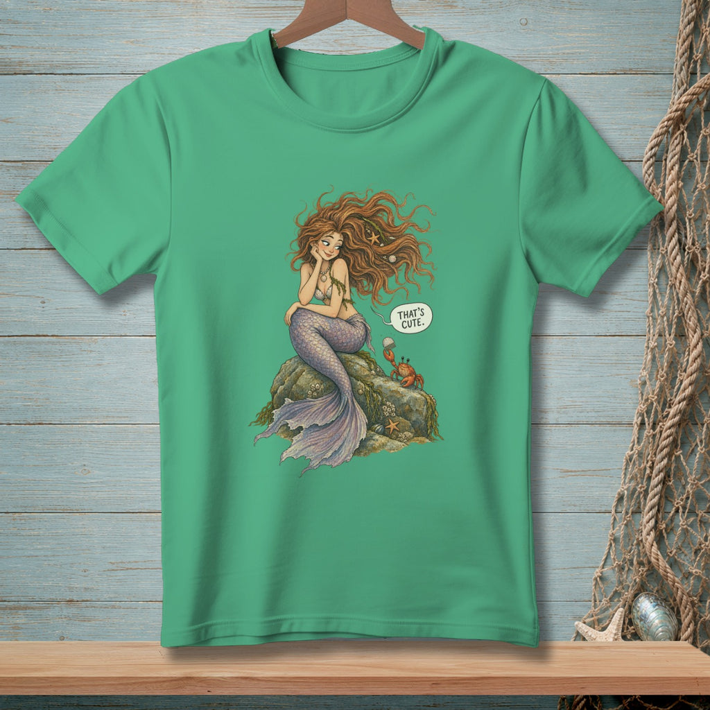 Green t-shirt with a mermaid sitting on a rock, a crab, and a speech bubble.