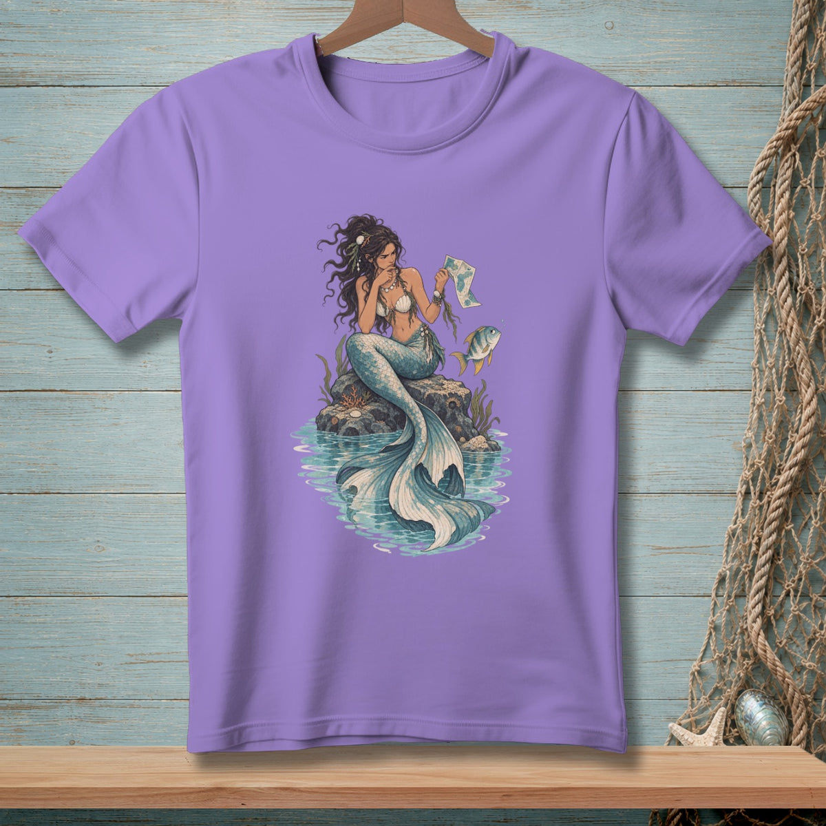 Mermaid sitting on a rock with a map, next to a fish.