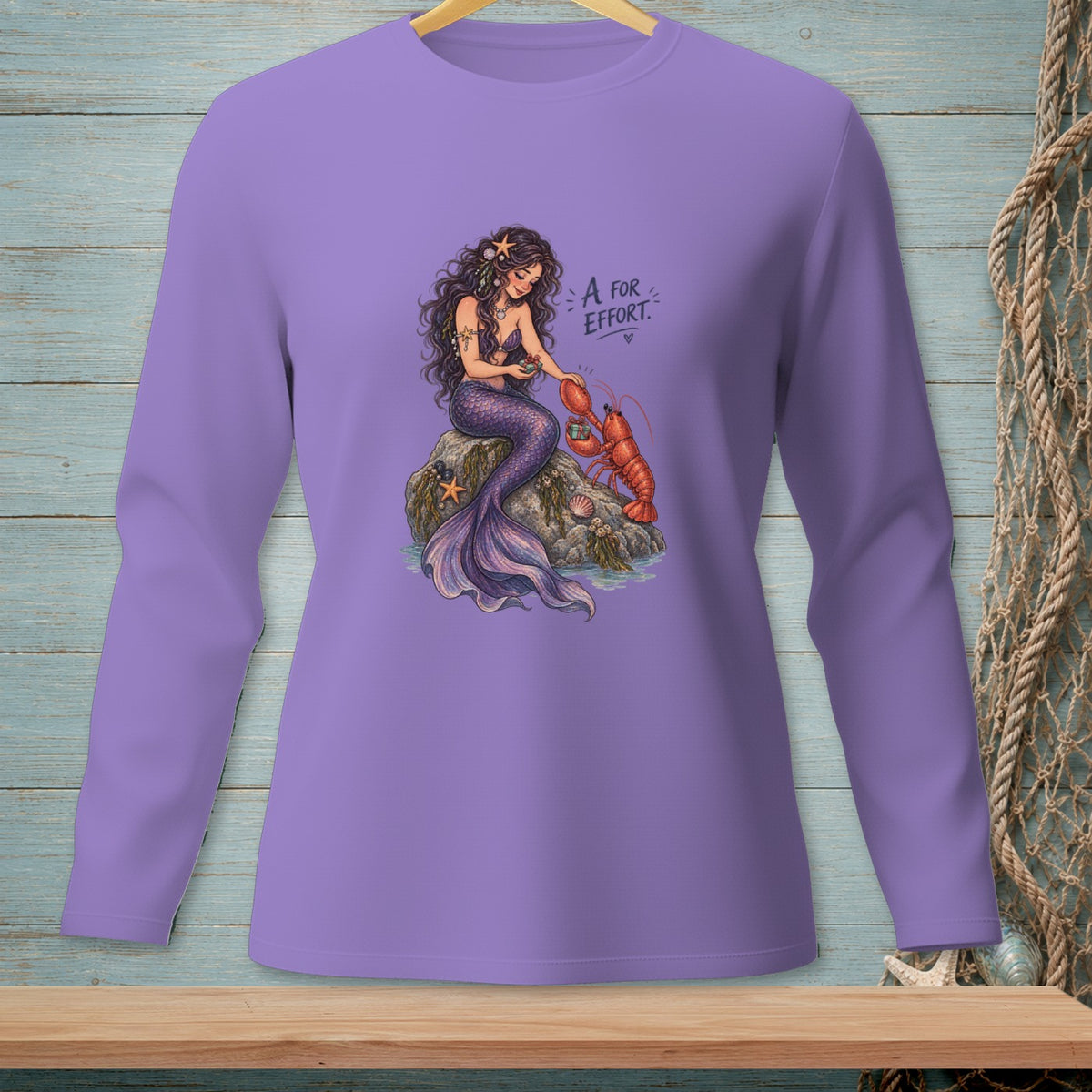 Mermaid with lobster and text "A for Effort" on lavender long-sleeve shirt.