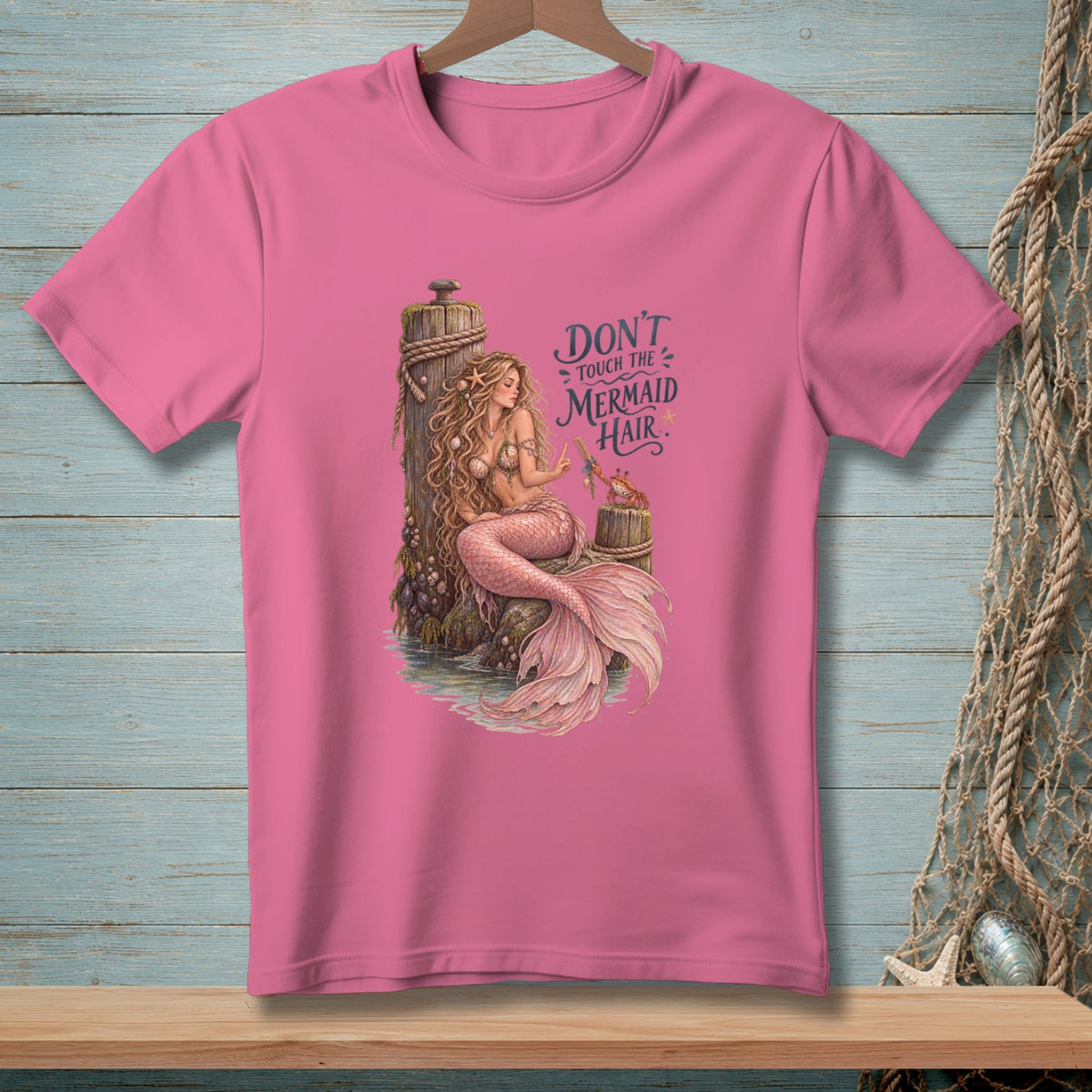 Pink t-shirt with a mermaid illustration and text "DON'T TOUCH THE MERMAID HAIR".
