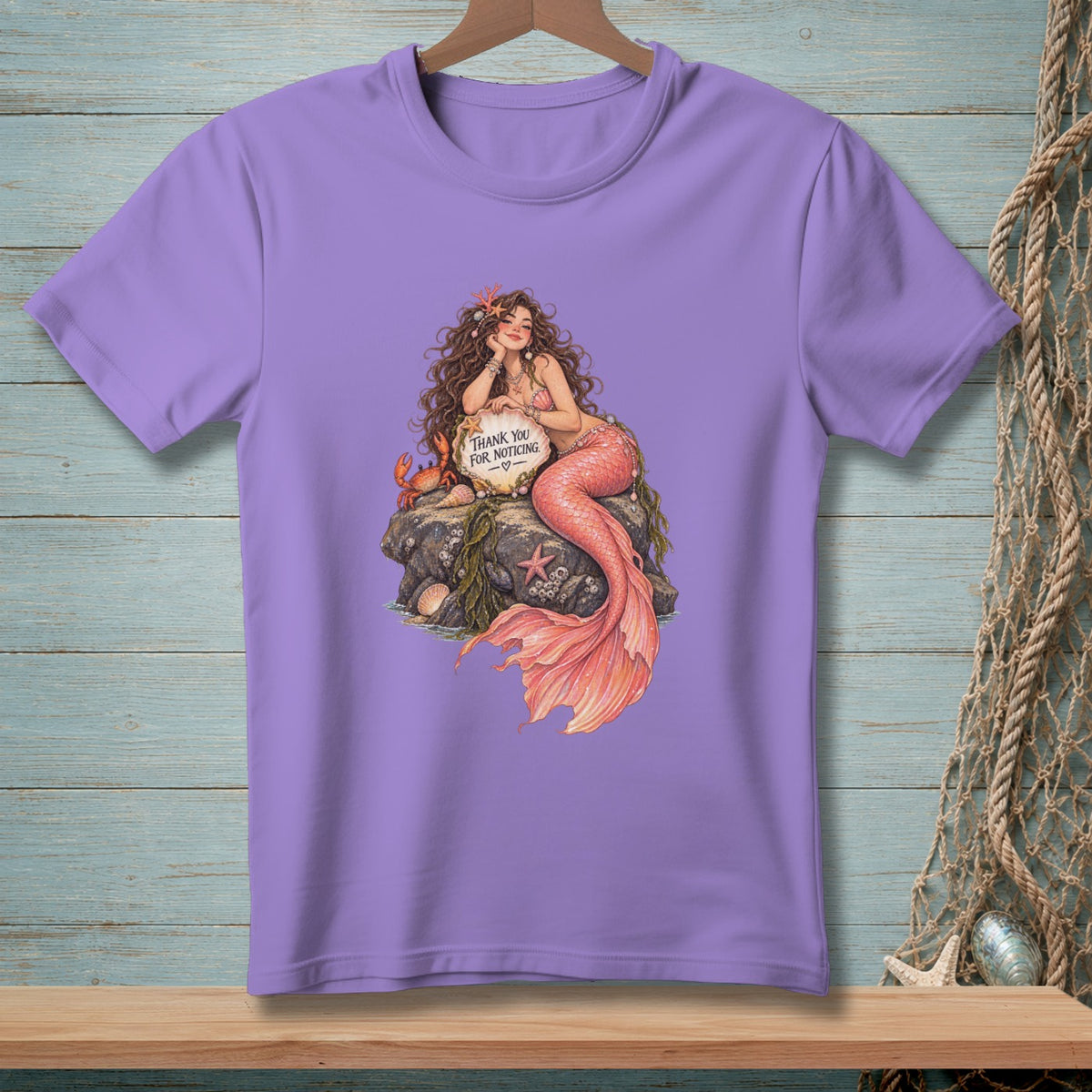 Purple t-shirt with mermaid illustration holding sign that says "Thank You For Noticing".