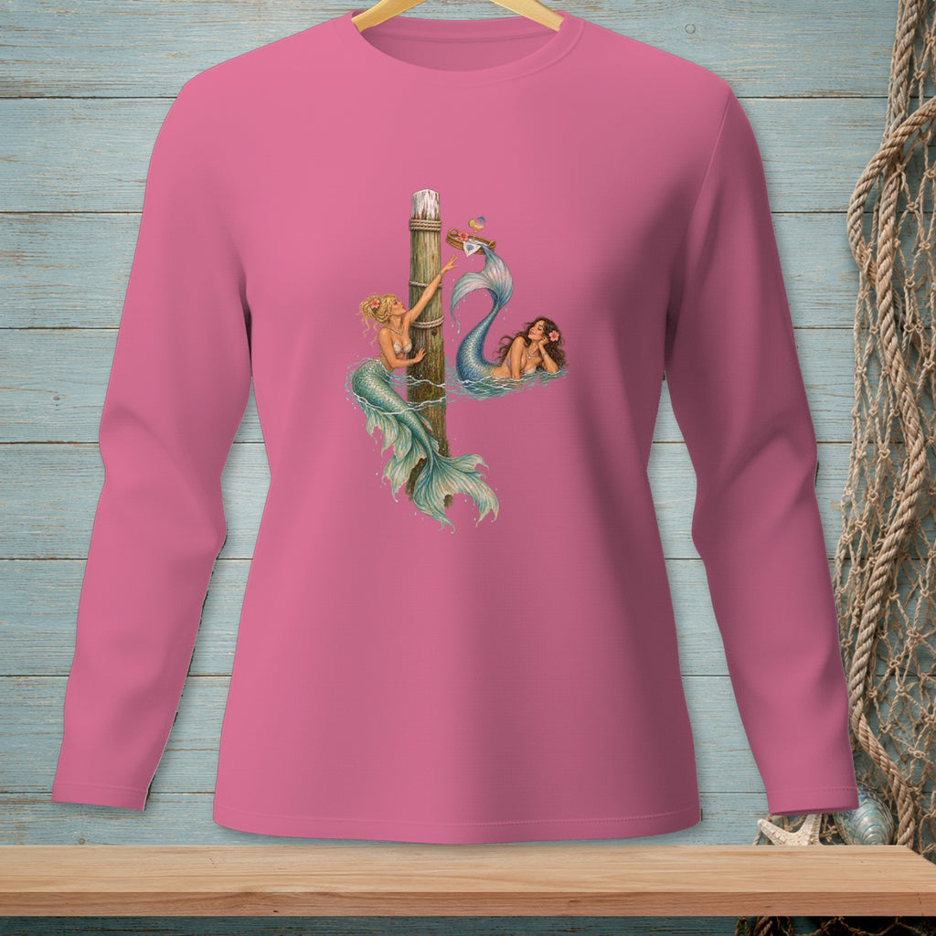 Pink long-sleeve shirt with two mermaids and a wooden post graphic.