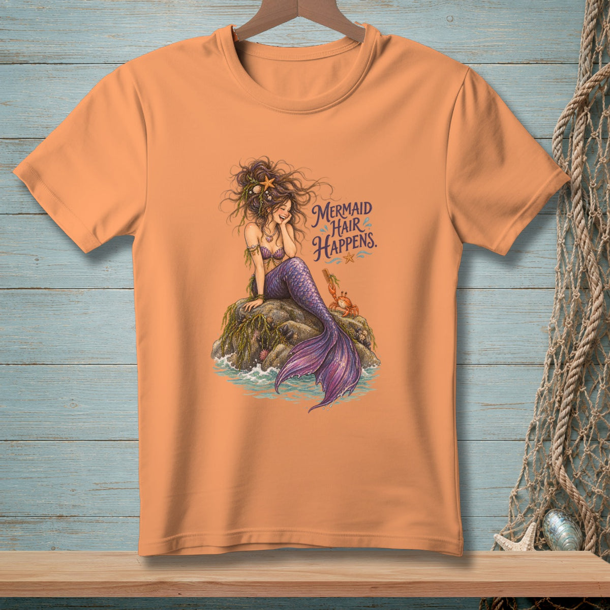 Peach t-shirt with mermaid graphic and text "Mermaid Hair Happens."