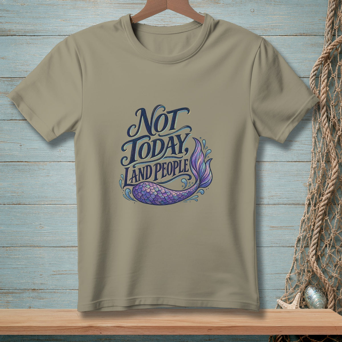 Taupe t-shirt with "Not Today, Land People" text and a purple mermaid tail.