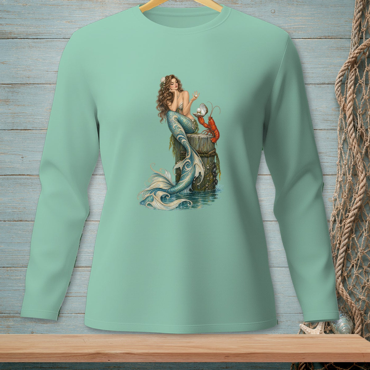 Long-sleeve t-shirt with a mermaid, lobster, and pearl illustration.