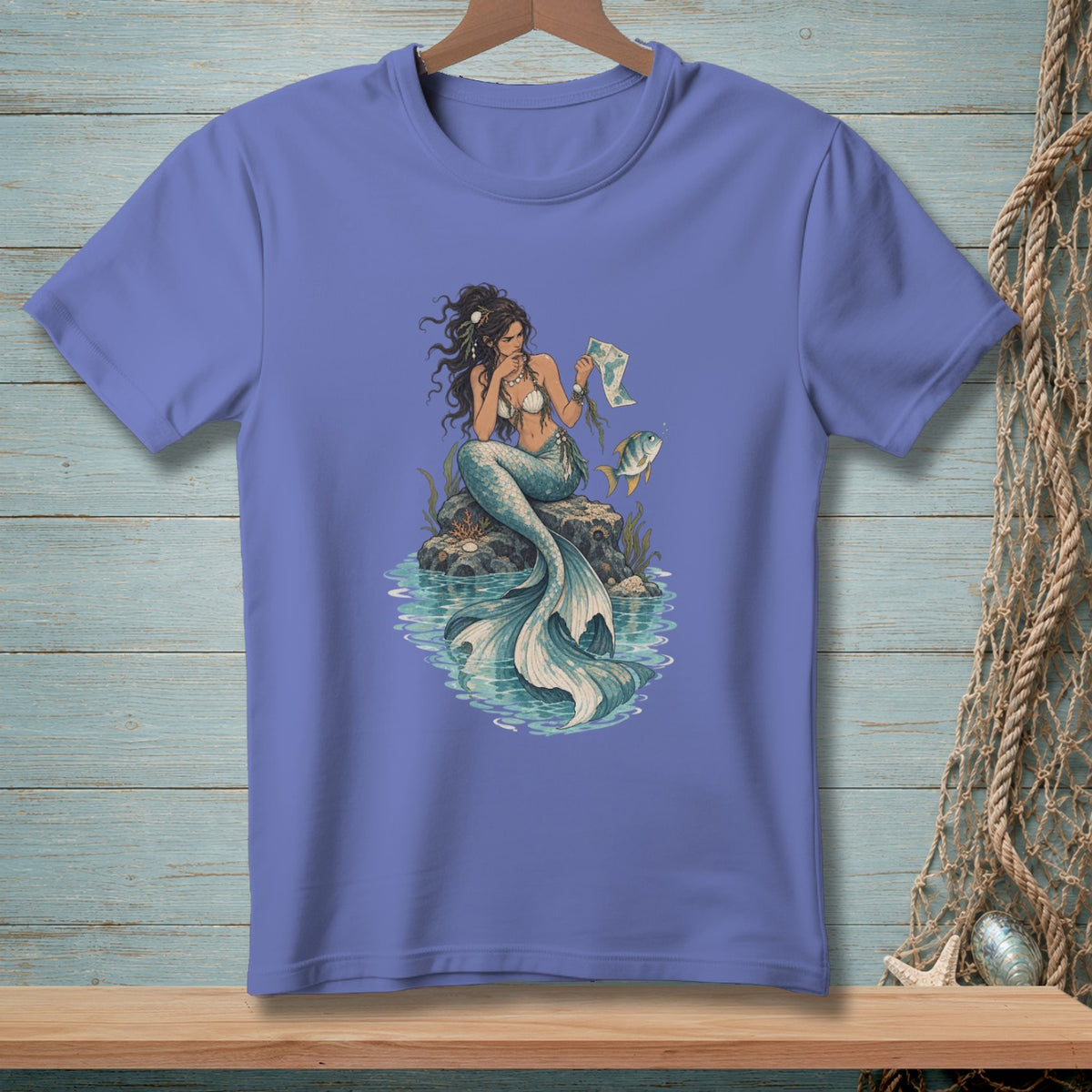 Mermaid sitting on a rock, holding a map, with a fish swimming nearby.