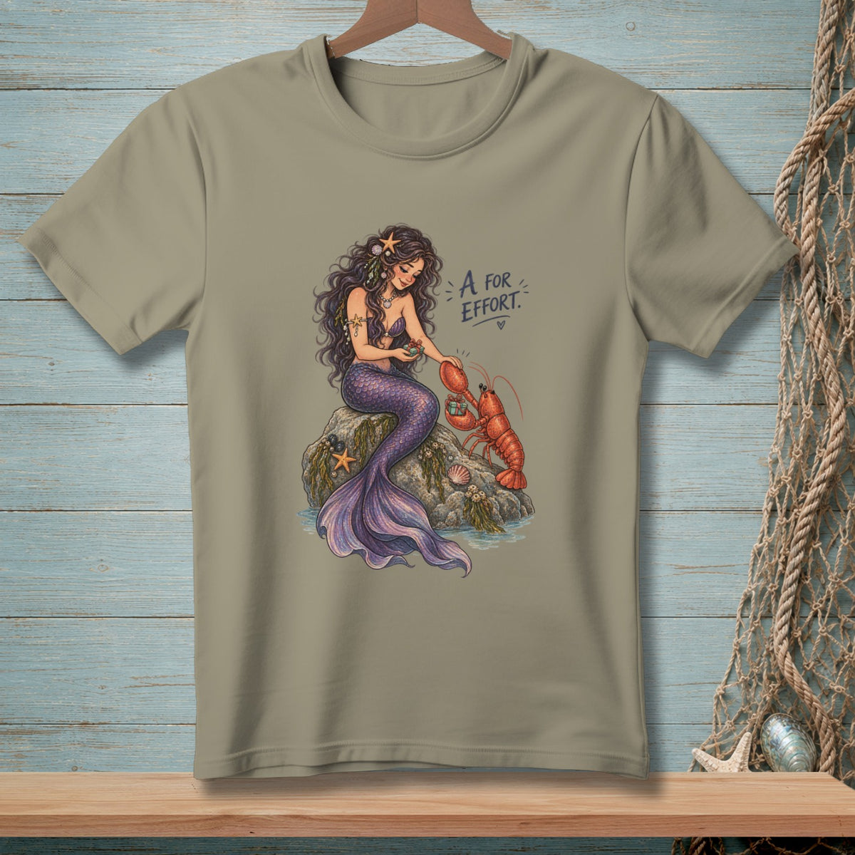 Mermaid with lobster and text "A for Effort".