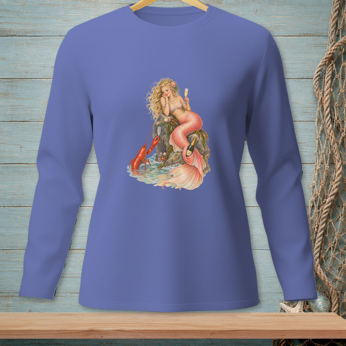 Long sleeve shirt with a mermaid, lobster, champagne, and rocks graphic.