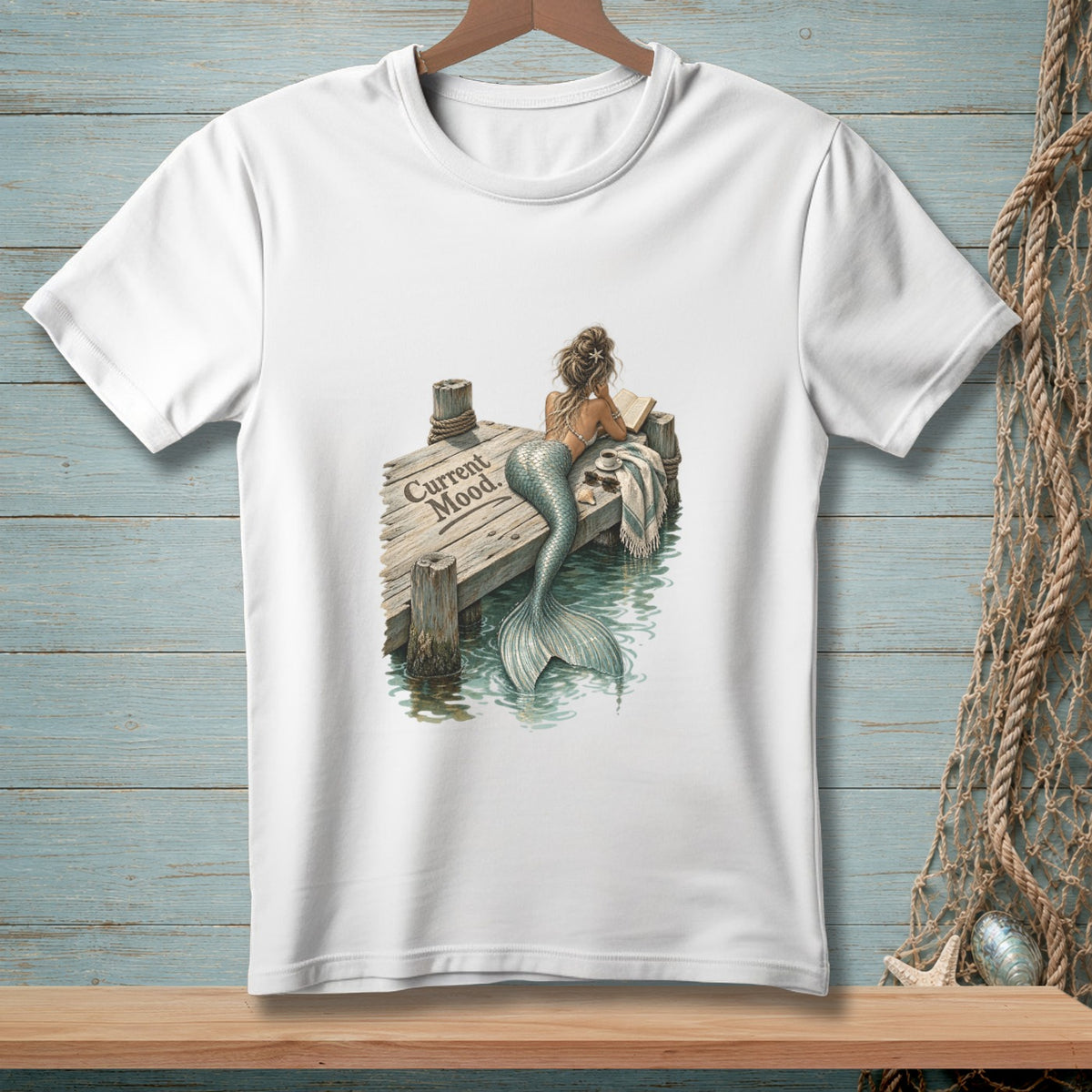 White t-shirt with mermaid on dock reading, "Current Mood" text.