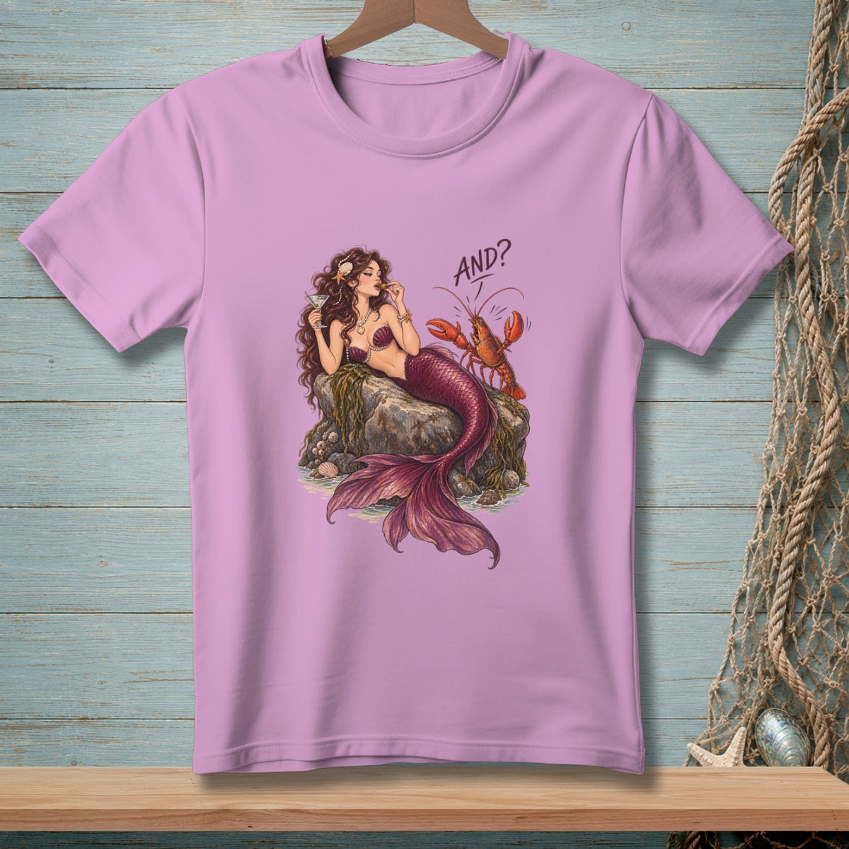 Mermaid with martini and lobster on a rock, text "AND?".