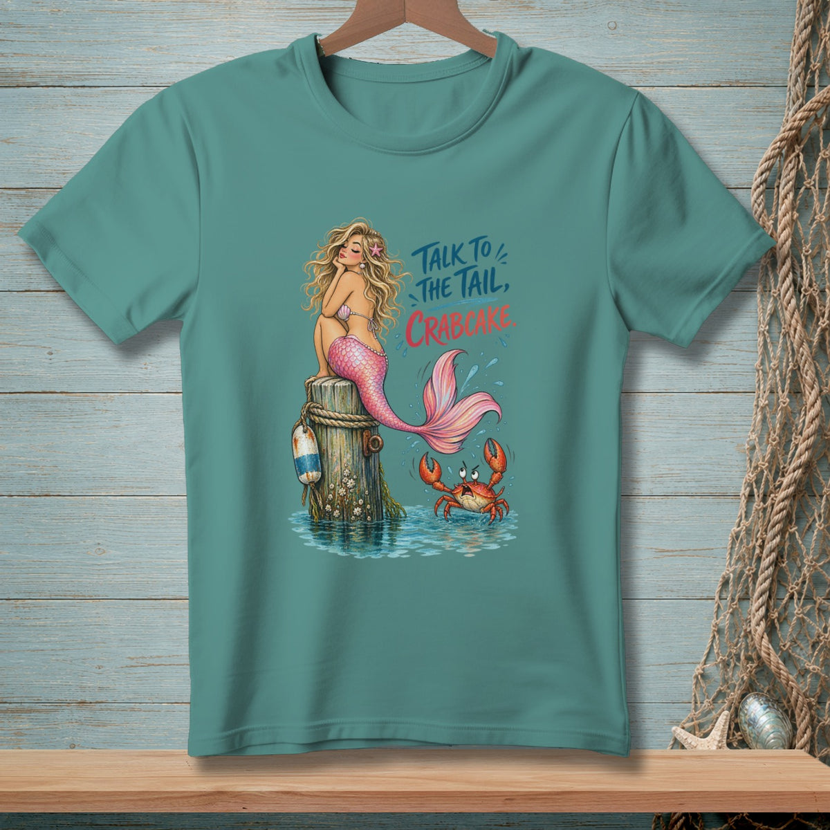 Mermaid on post with crab and text "Talk to the tail, crabcake."