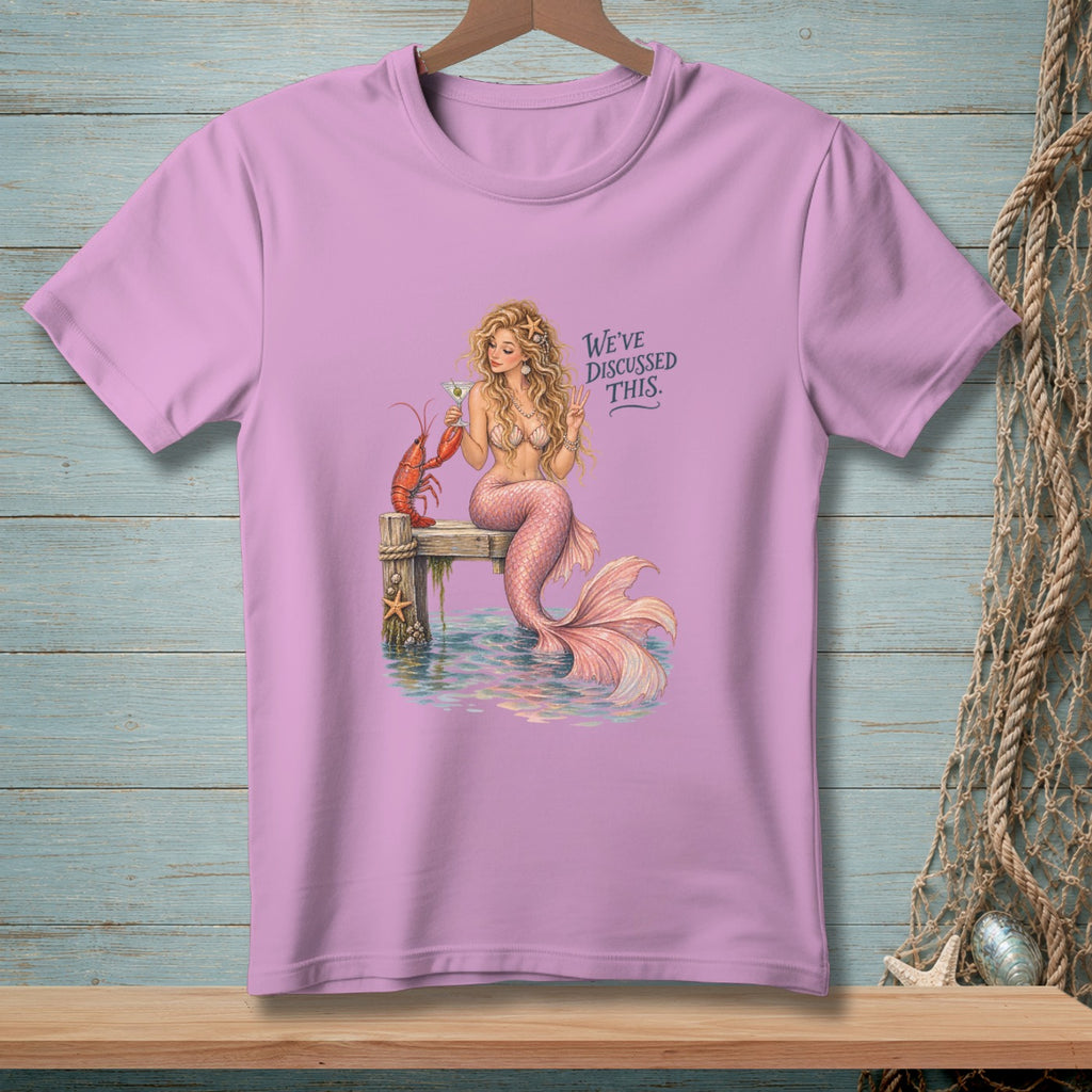 Mermaid with lobster and drink on dock, text "WE'VE DISCUSSED THIS."