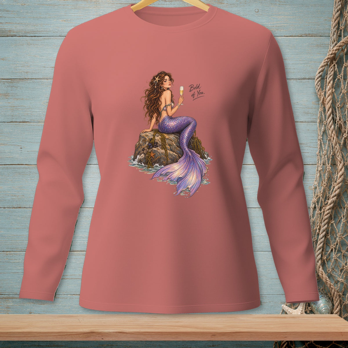 Coral long-sleeve shirt with mermaid art and text "Bold of You."