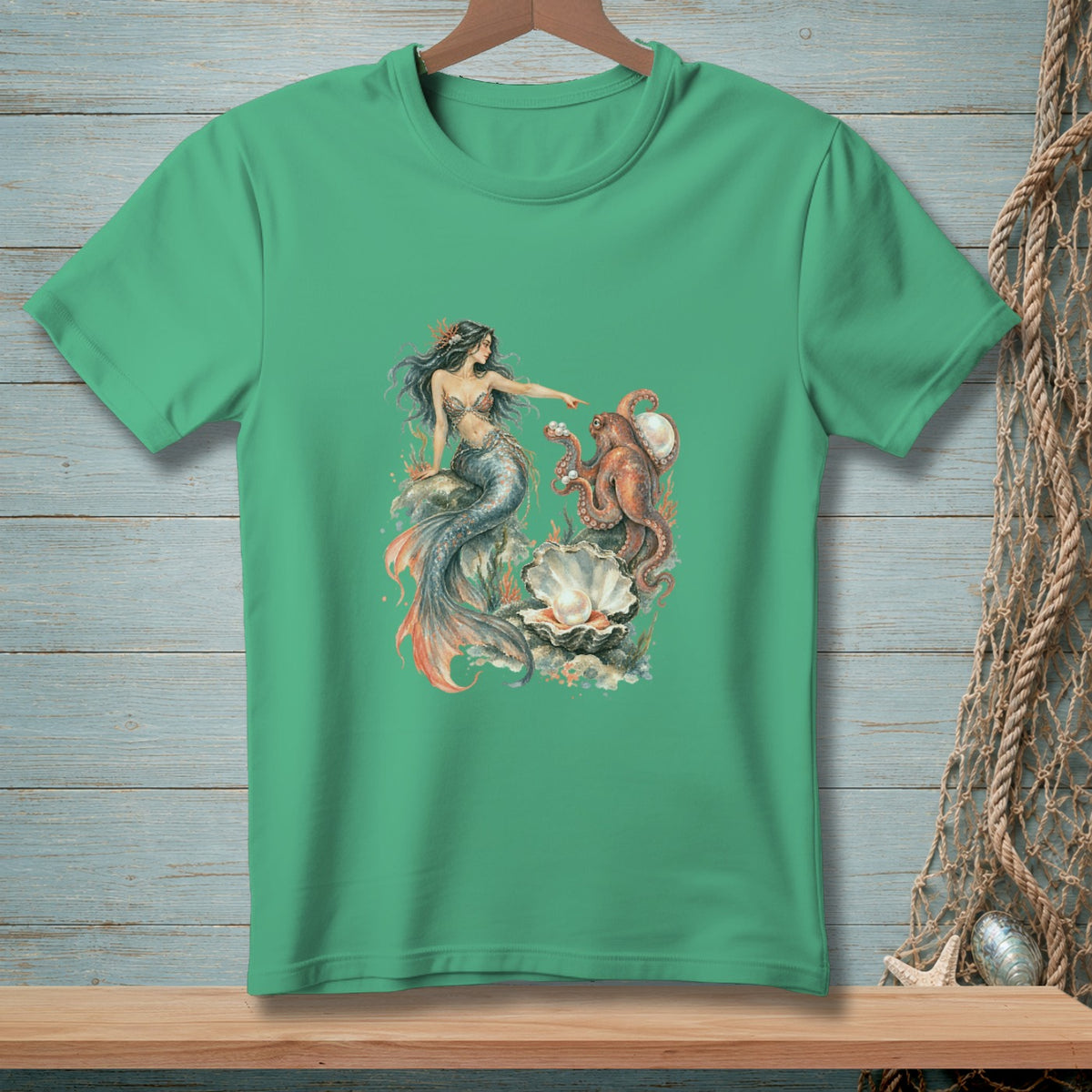 Green t-shirt with a mermaid pointing at an octopus beside a large pearl.