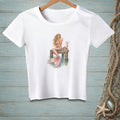 White t-shirt with a mermaid sitting on a dock next to a crab and a "Be Nice" sign.