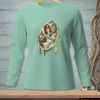Mermaid relaxing in a boat filled with flowers and books on a teal long-sleeve shirt.